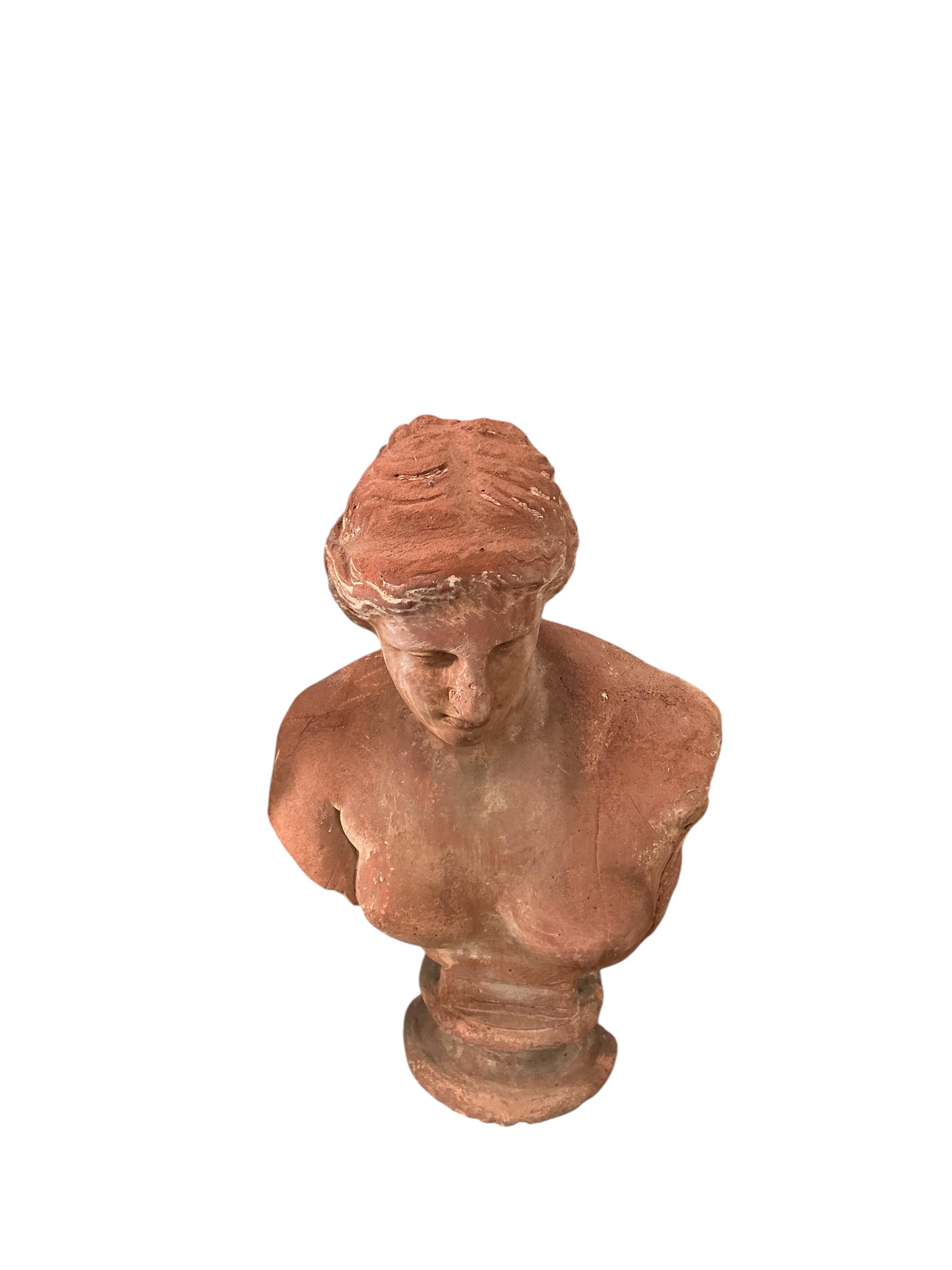 A pair of Neoclassical Revival terracotta busts on fluted pedestals, larger height 188cm, Provenance: The late Kenneth Turner (1936-2025), celebrity florist, designer and perfume retailer, he received the Royal Warrant f